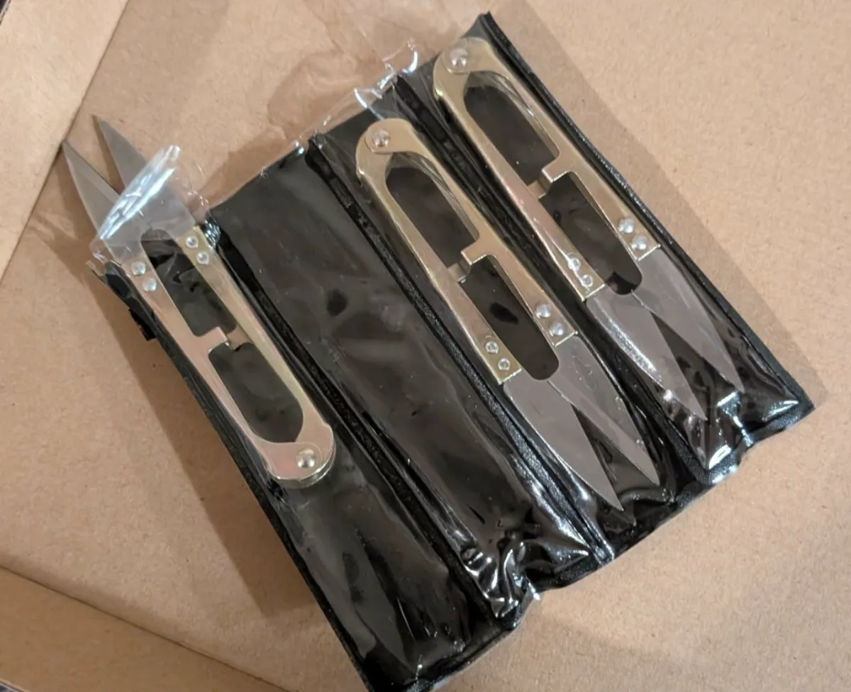 Three AI scissors in packaging